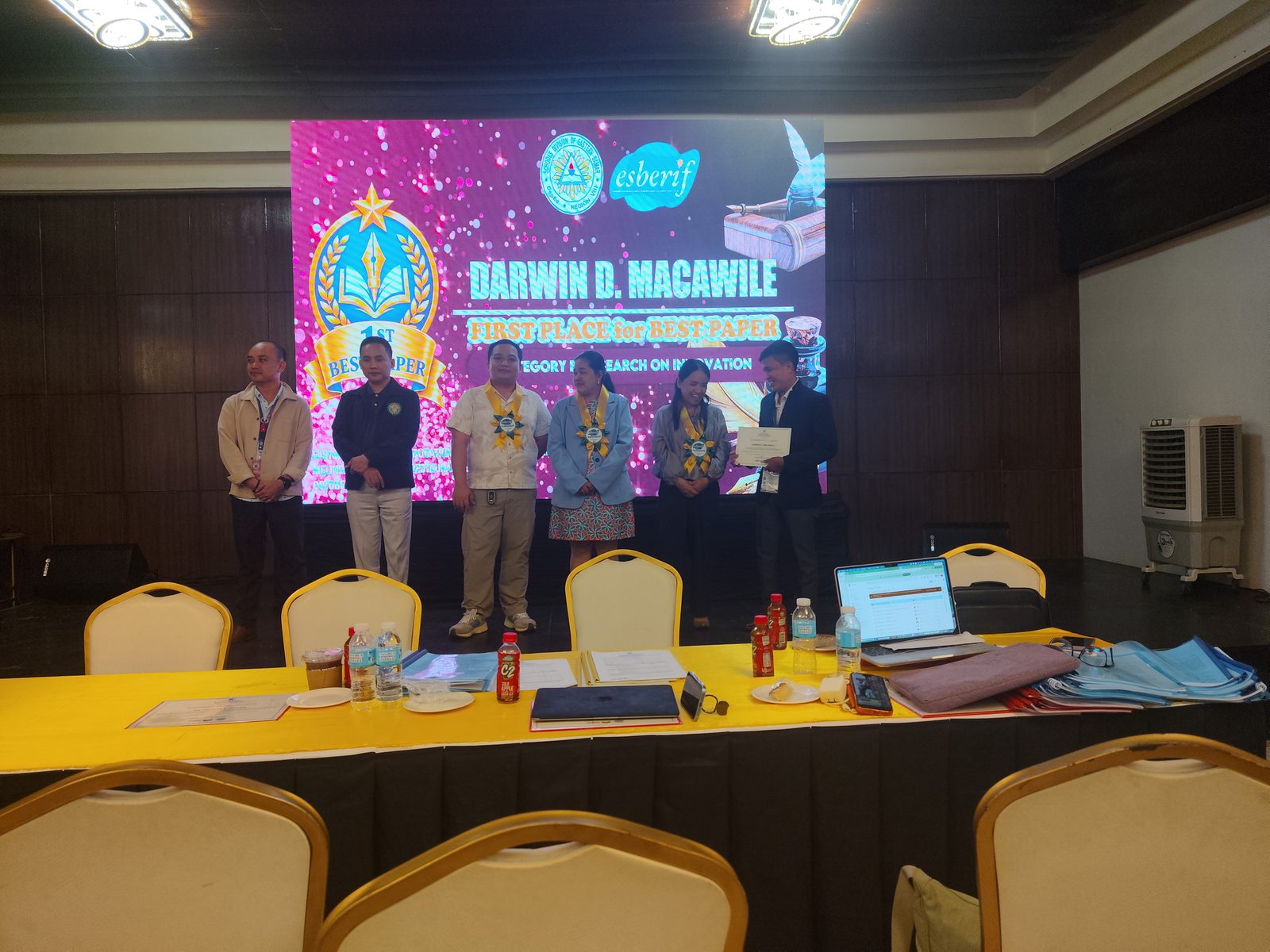 First Place, Best Paper, on the awarding ceremony stage